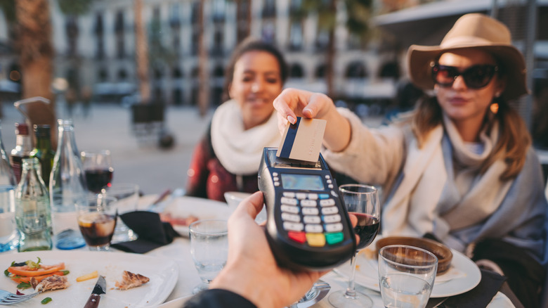 People in Europe paying their restaurant bill at the table