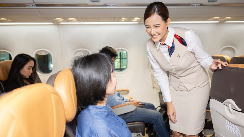 Flight attendant speaking to a passenger