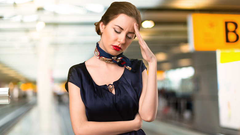 Annoyed flight attendant in an airport