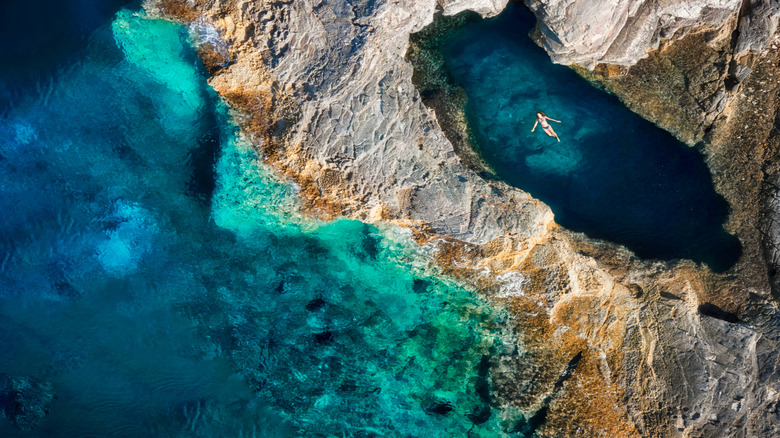 A swimmer rests in a coastal lagoon on the shores of Croatia
