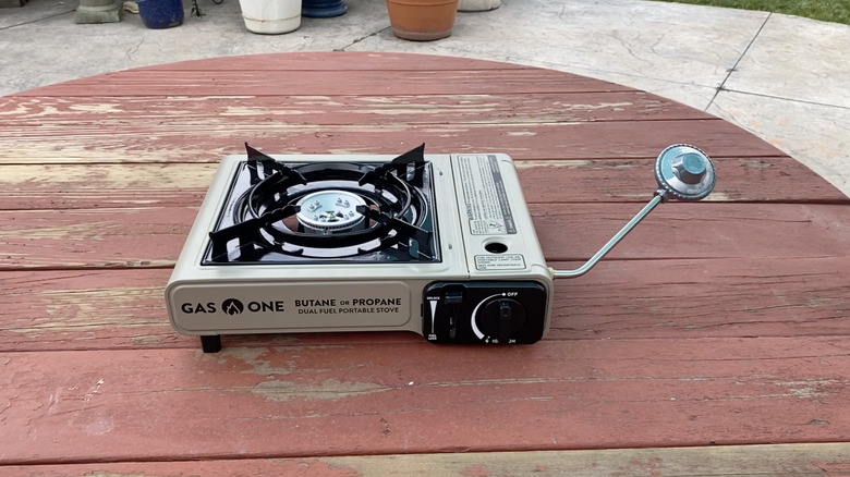 Gas One Dual Fuel Camping Stove on a wooden table