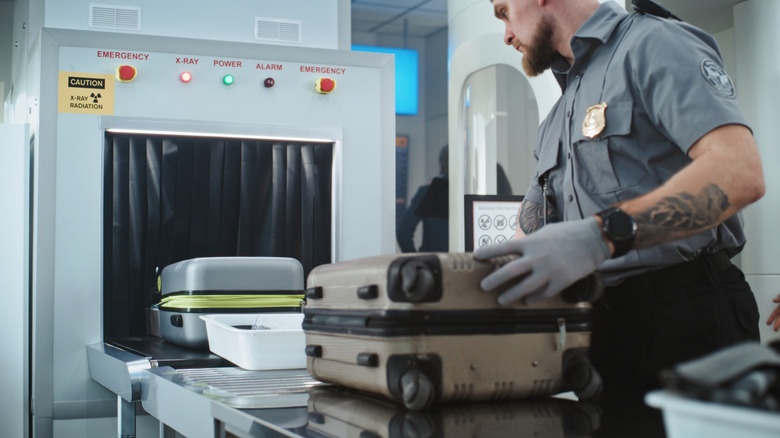 Luggage going through a security scanner