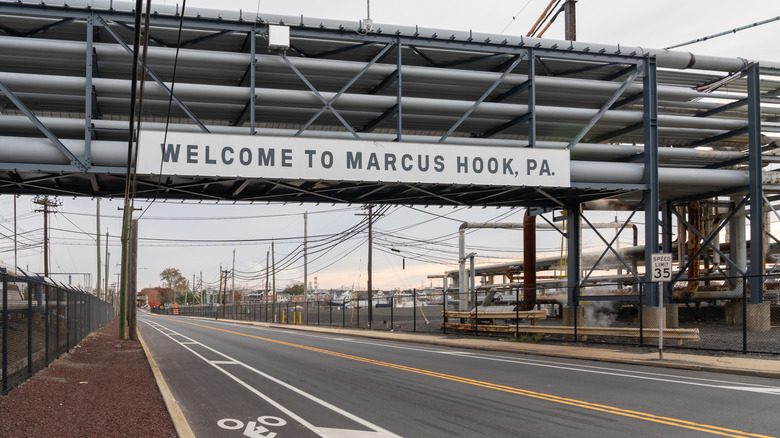 View of an overpass sign reading "Welcome to Marcus Hook, PA" over a roadway.