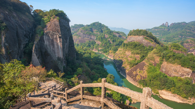 A river between greenery and granite peaks in Wuyi Mountains National Park