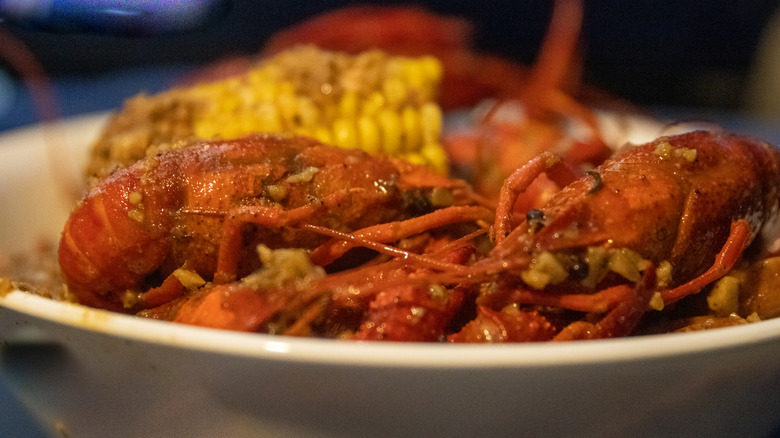 Closeup of a crawfish boil meal with sausages in a bowl