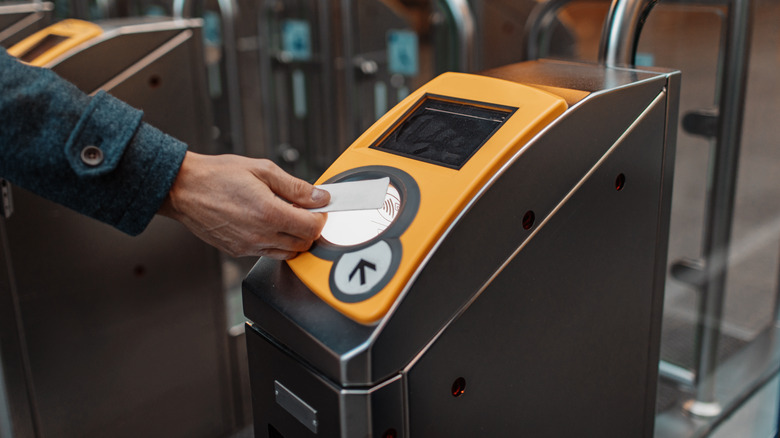 Person tapping into Dutch train gate
