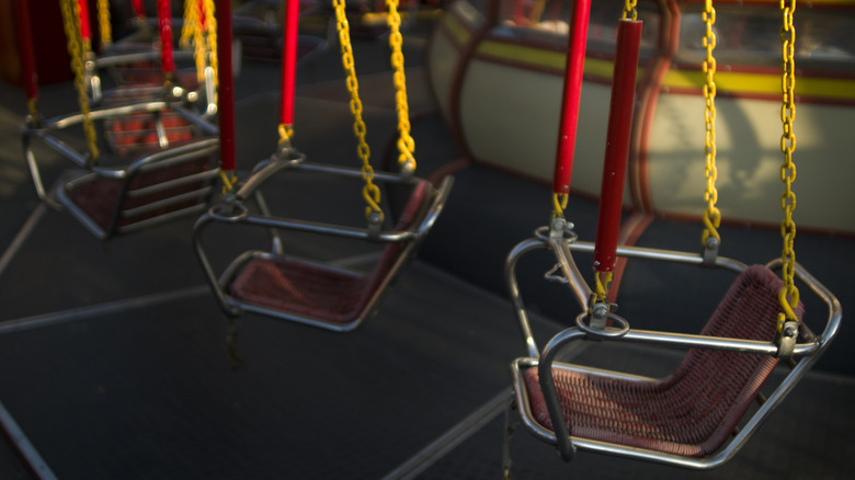 Never-used rides hang in an abandoned theme park