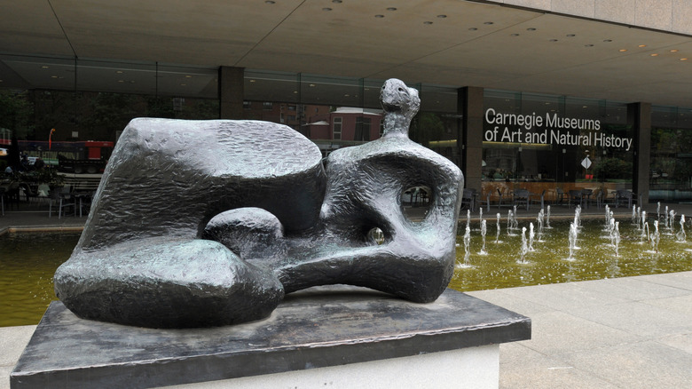 A sculpture and fountain outside of the Carnegie Museums of Art and Natural History