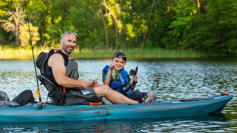 A father and son in a kayak with life jackets