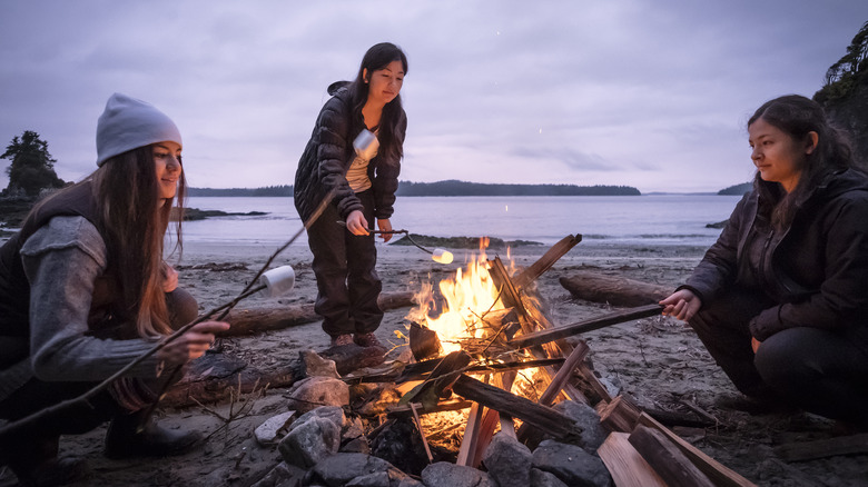 Women huddled around a campfire