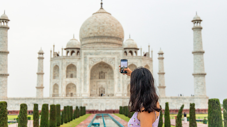 Woman taking a selfie by the Taj Mahal