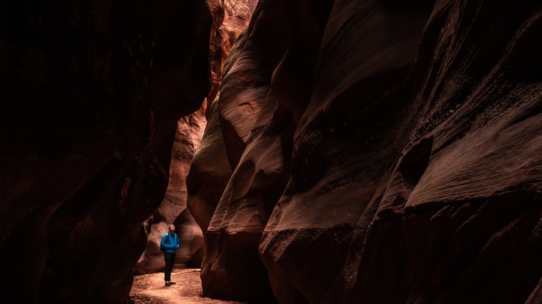 hiker in dark narrow buckskin gulch