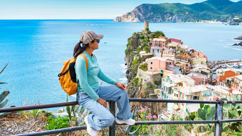 A hiker looks down at Vernazza in the Cinque Terre
