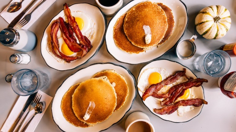 Classic American diner bacon, eggs, pancakes, and coffee.