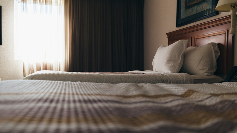 Bedspreads on beds in motel room
