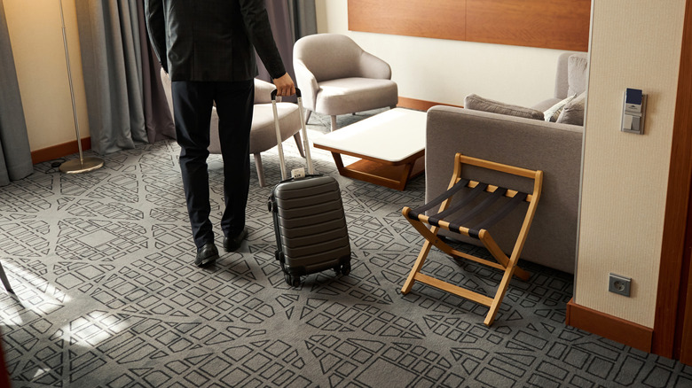 Hotel guest arriving at carpeted room