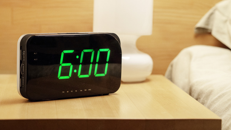 Hotel room alarm clock by bed