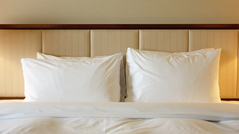 Hotel room bed with pillows and headboard