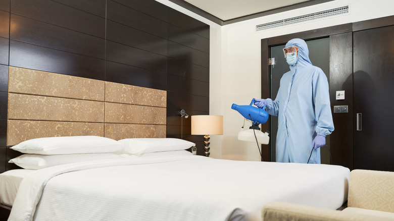 Employee disinfecting hotel room for guest