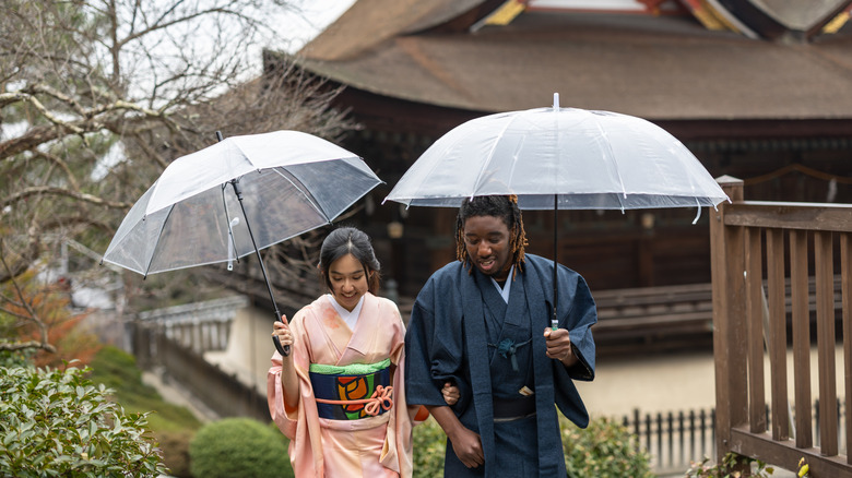 A couple walks through Japanese shrine grounds