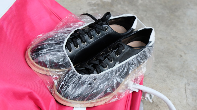 Pair of shoes in clear shower cap