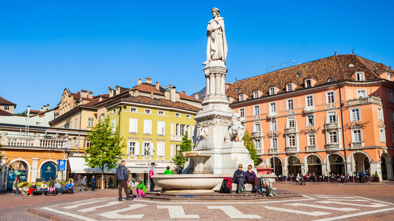 Tourists sitting in Piazza Walther Platz, Bolzano.