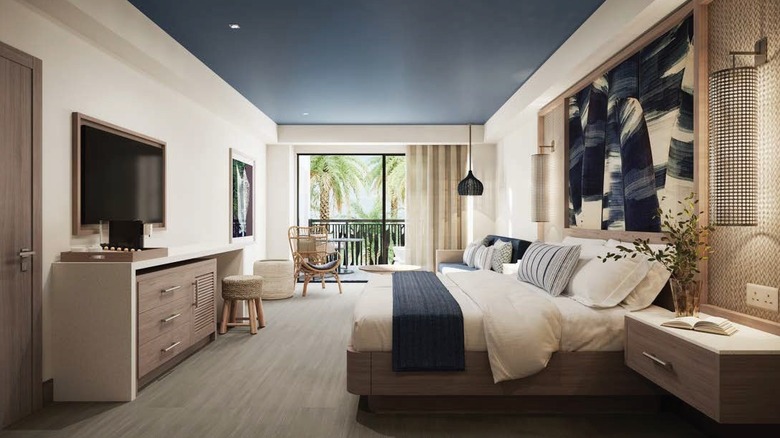 a room designed around a water centric concept, with a cream and blue color scheme, in Lopesan Splash Cove