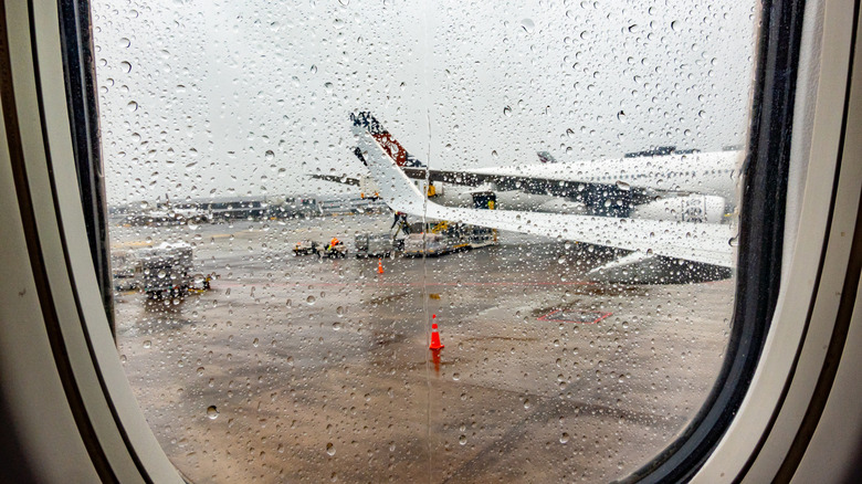 Airplane window with rain