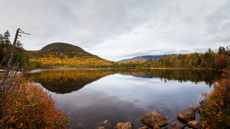 Lonesome Lake in New Hampshire ringed with fall colors and mountains reflected on its surface