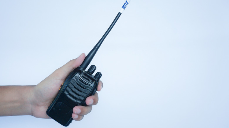 Hand holding a walkie talkie