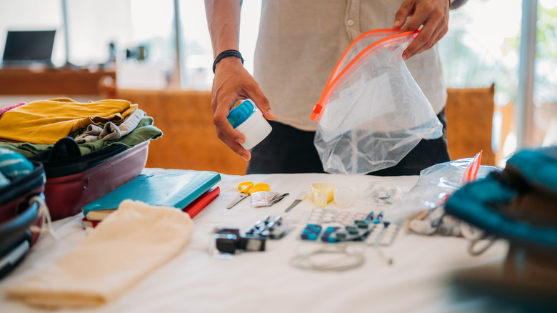 A man storing medicines inside a resealable bag.
