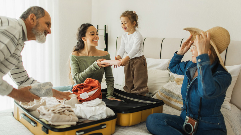 A family packing with a kid