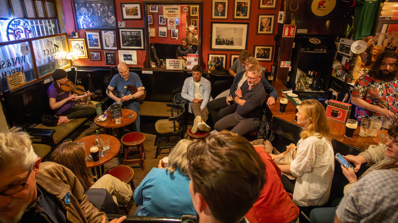 Audience listening to a band playing in an Irish pub.