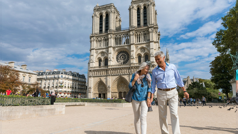 Senior couple in front of the Notre Dame cathedral in Paris