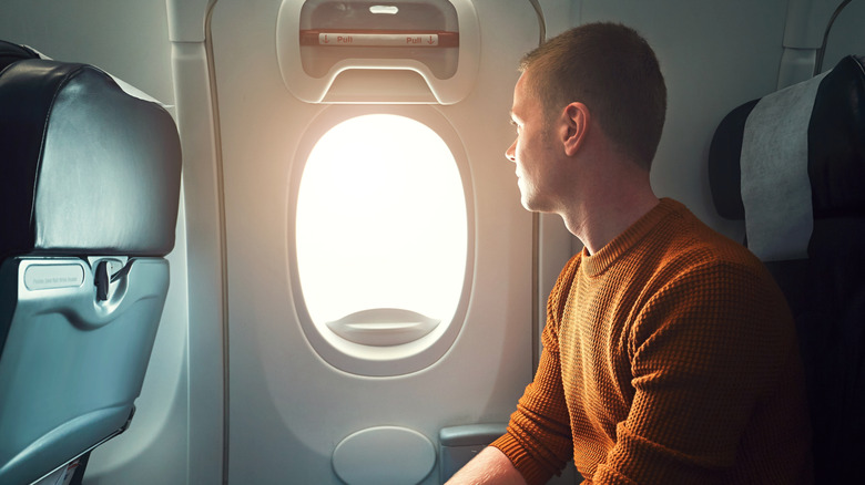 Exit row passenger staring out window