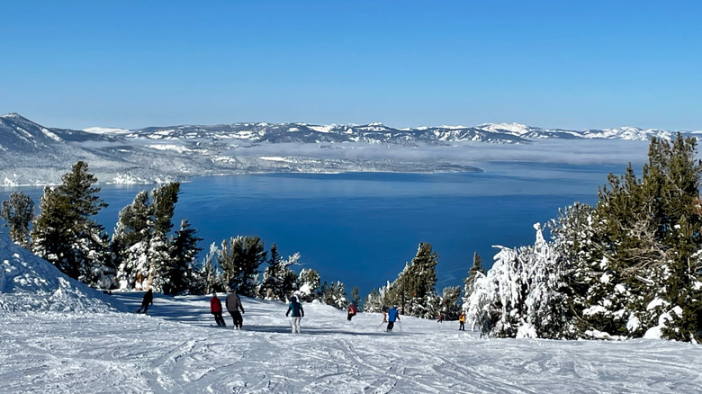 Skiers at a Tahoe ski resort with Lake Tahoe in the background in California