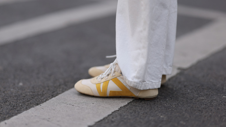 Model and fashion influencer Sonia Lyson wearing Louis Vuitton's beige Sneakerina shoes in Berlin