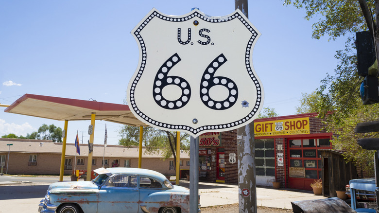 A Route 66 sign and vintage car in the background in Seligman, Arizona