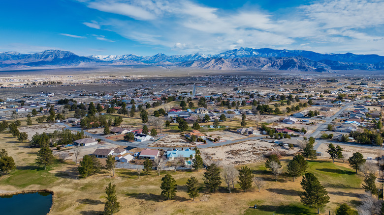 An aerial view of Pahrump, Nevada, a semi-rural town expanding towards snow-capped mountains