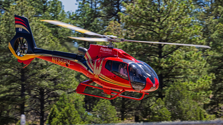 A red helicopter departs from Grand Canyon Airport in Tusayan, Arizona