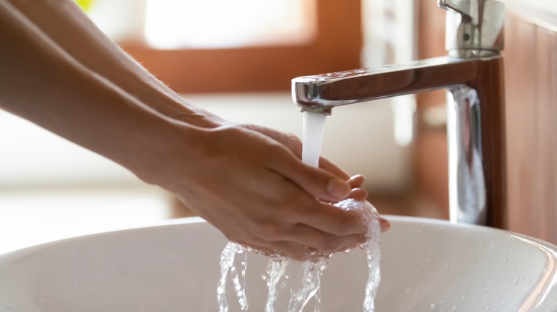 Washing hands in hotel sink