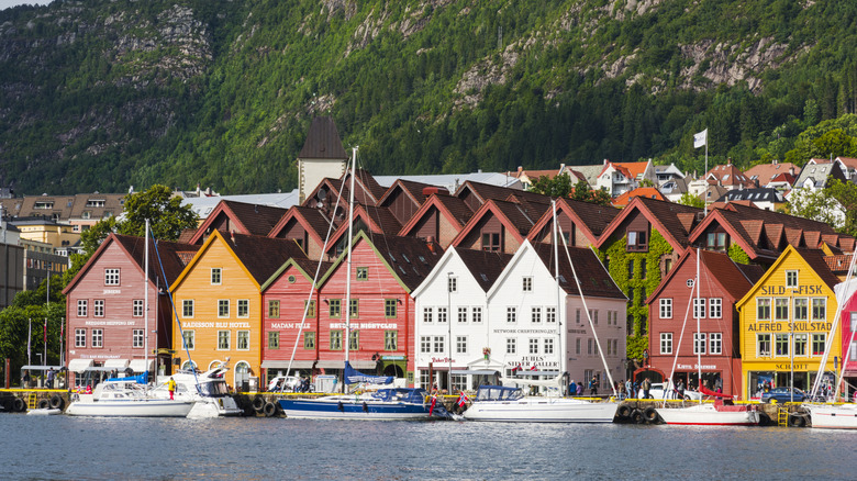 Beautiful coastal houses with lively colors and calm reflection in Bergen, Norway