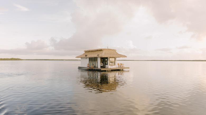 a floating bungalow on a lagoon on a cloudy day