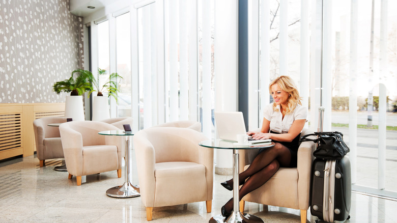 woman using laptop in hotel lobby