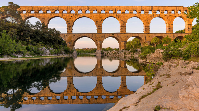 Pont du Gard reflecting in the water below, Nîmes, France