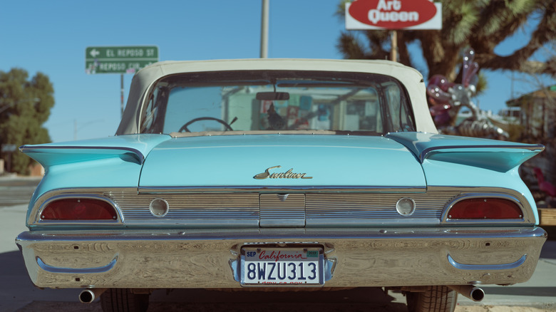 The tail lights and license plate of a Vintage Ford parked in Yucca Valley, California