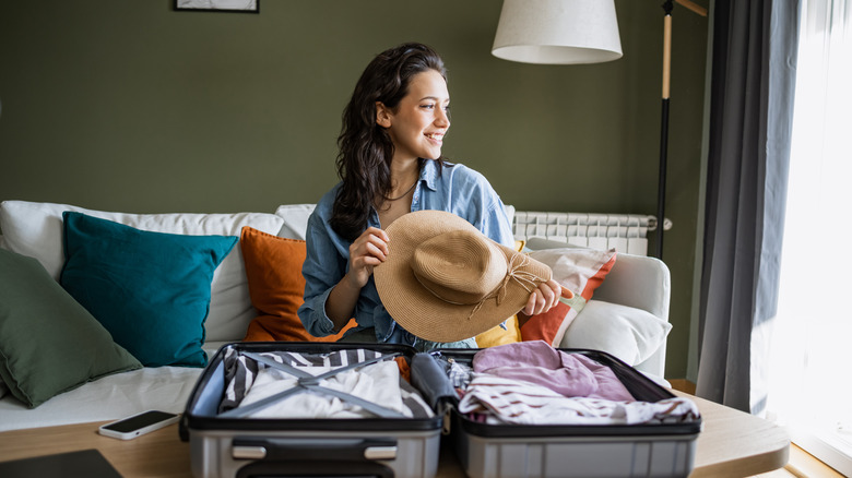 Woman unpacking suitcase