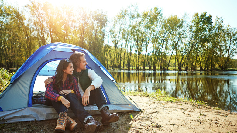 A couple at the entrance of their tent