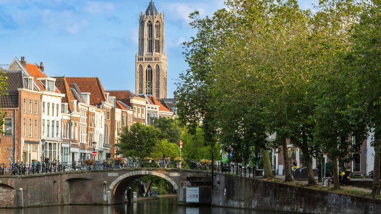 Dom Tower with historic buildings along a canal in Utrecht, the Netherlands