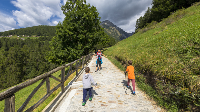 Young hikers on a path in the Valcamonica